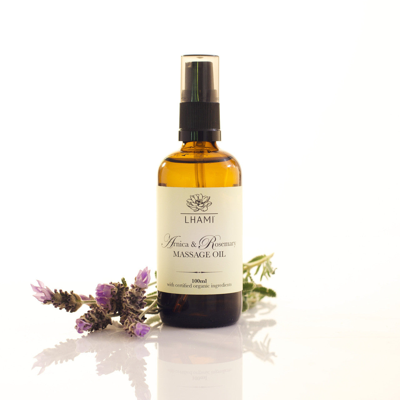 Bottle of Lhami massage oil with lavender flowers on a white background