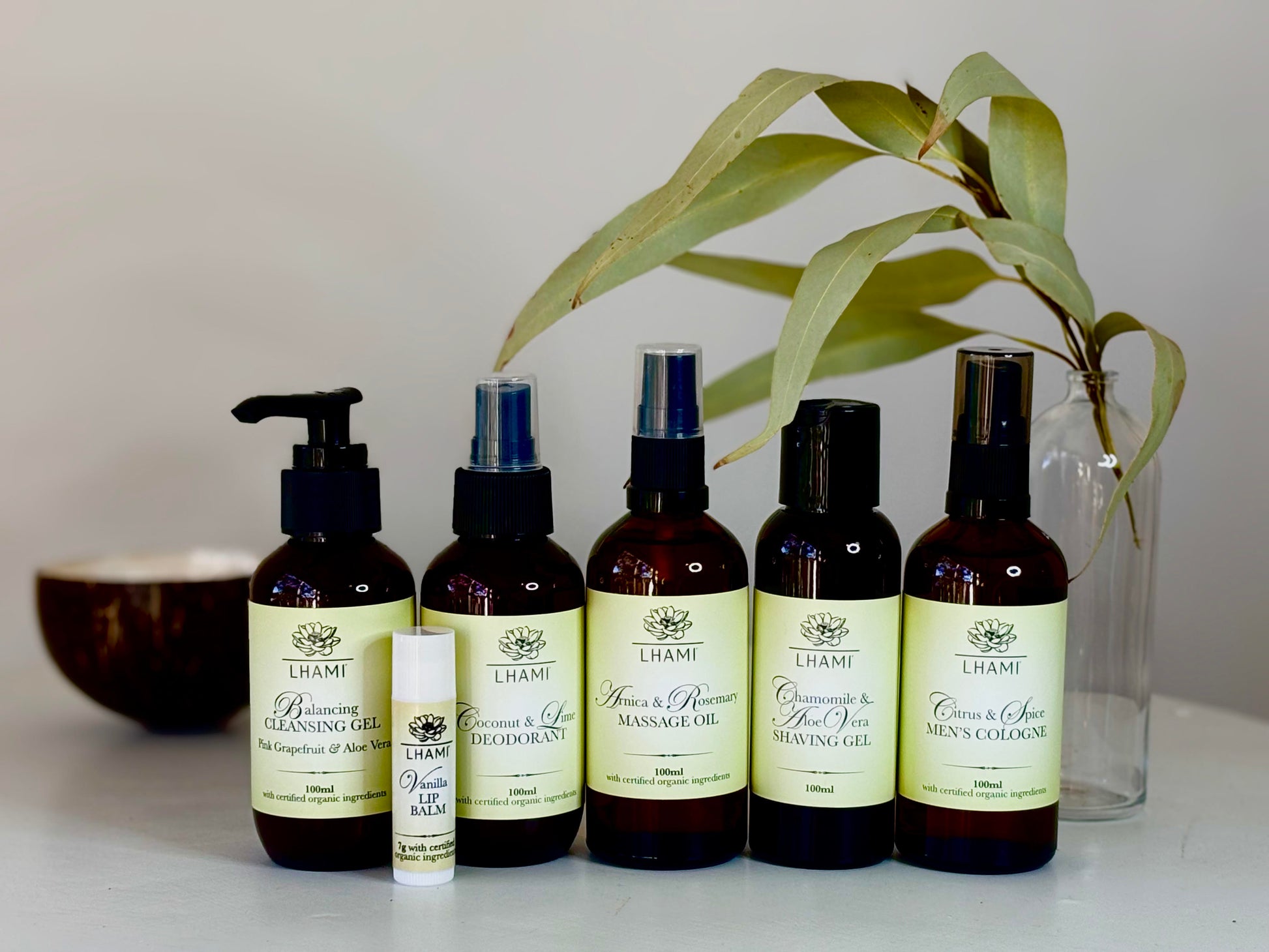 Set of Lhami skincare products on a white surface with a plant in the background