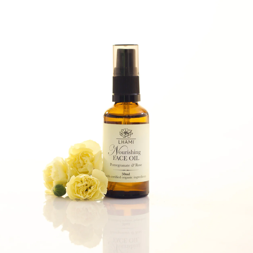 Chamomile nourishing face oil bottle with flowers on a white background
